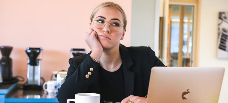 Picture of a woman that is thinking about how to avoid common moving scams