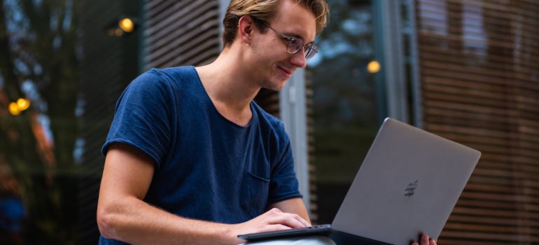 Man researching expenses to include in your moving budget on his laptop.