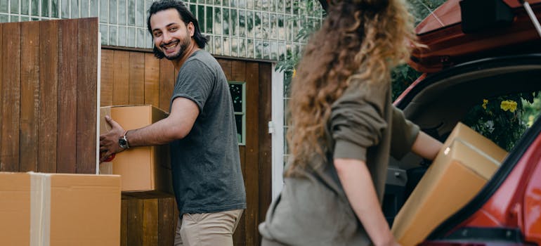 a man helping his new neighbor with moving boxes.