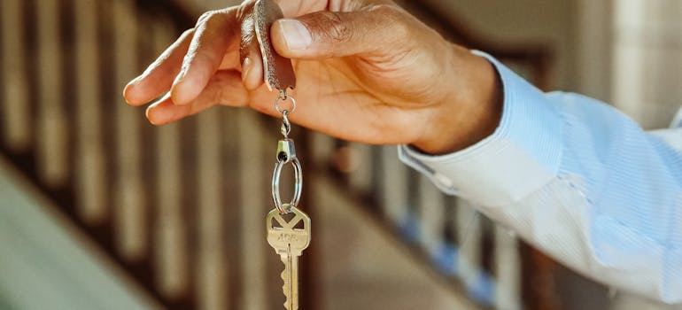 Man holding a house key.