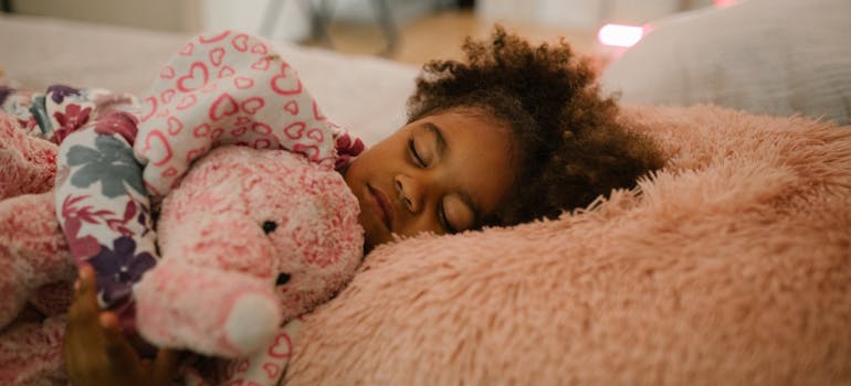Child sleeping with a toy.
