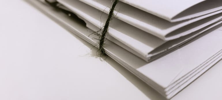 Stack of papers tied together with a black string.