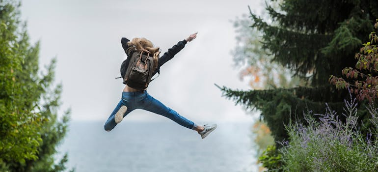 Woman jumping in woods.