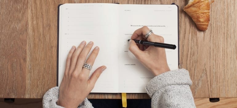 a person making a list and getting ready for moving from the USA to Victoria
