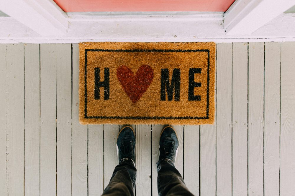 a person standing in front of a rug after learning how to move your entire household to Sidney BC
