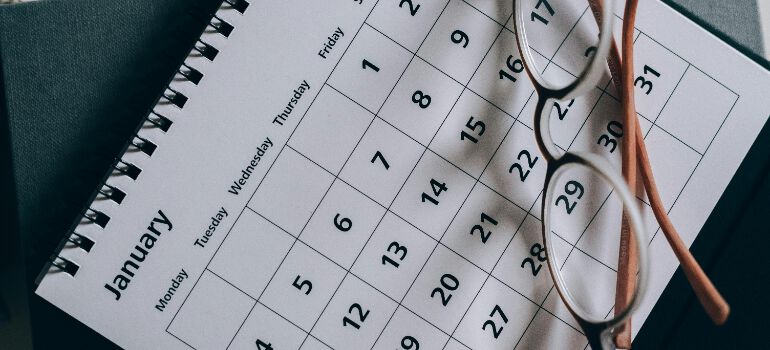 a calendar with glasses on top