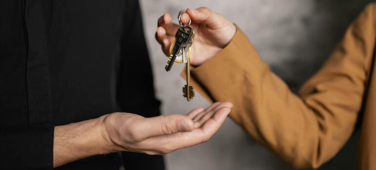 a person handing over the keys to a home