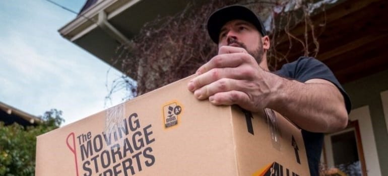 a moving professional carrying a box