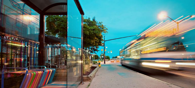 a bus passing by a station in the city
