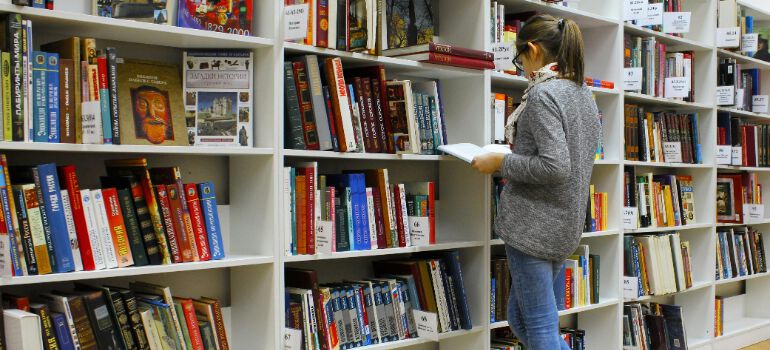 a girl reading a book in a library