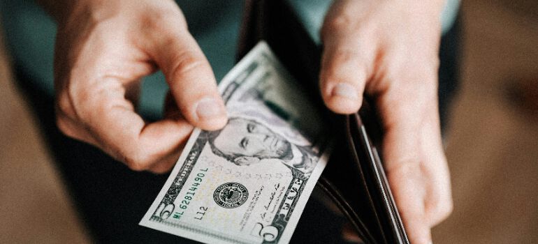a person counting money after relocating from Victoria to Vancouver