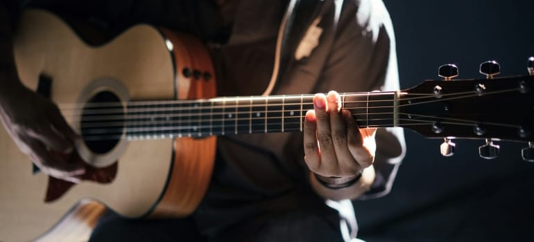 Picture of a person playing the guitar 