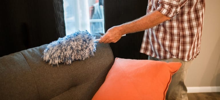 Picture of a person cleaning a couch 