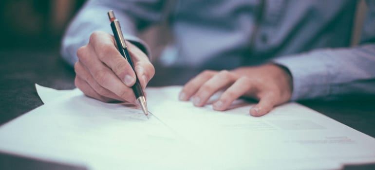  a person dealing with paperwork after moving to Ontario