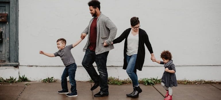 Family Of Four Walking At The Street