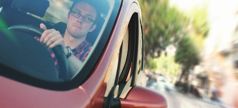 Man Driving the Red Vehicle