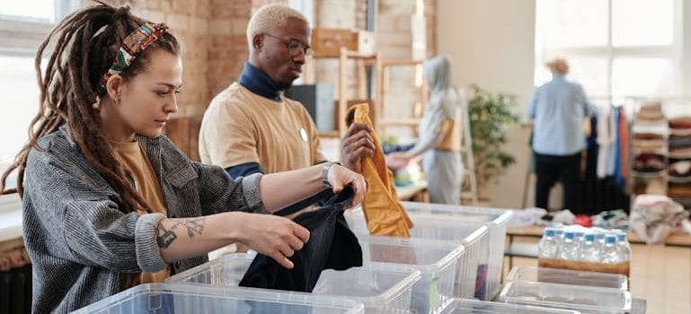 Woman with Dreadlocks Sorting Clothes