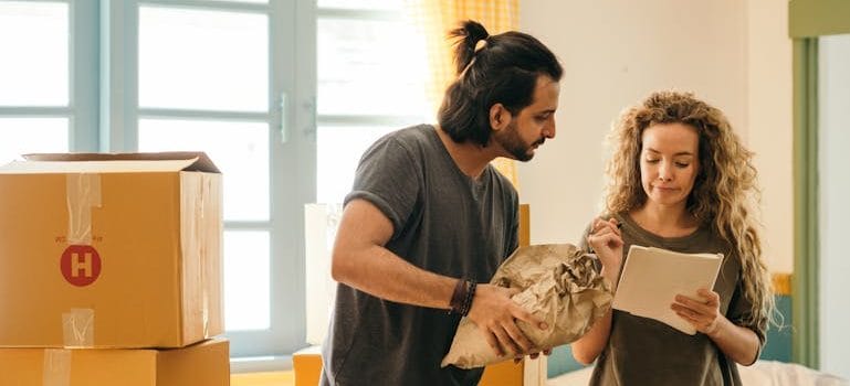 couple unpacking boxes in new home