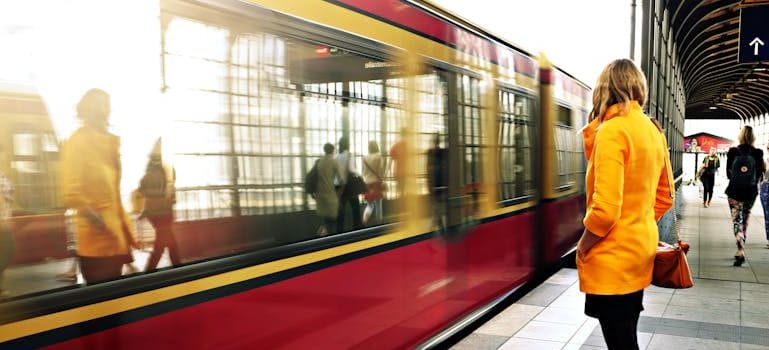 Woman Standing Beside Red Train