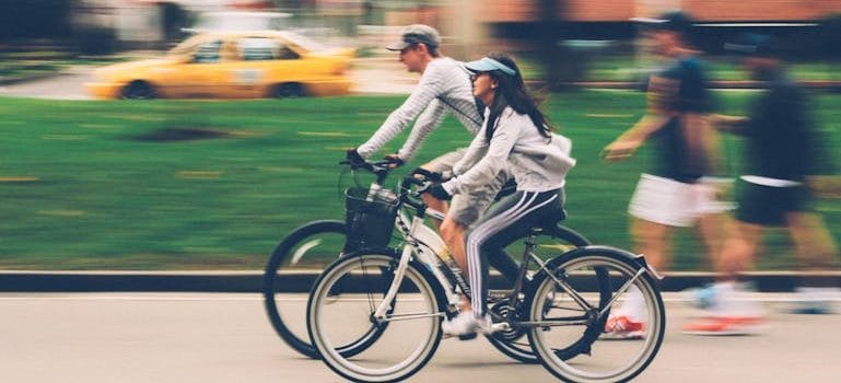 Woman and Man Riding on Bike