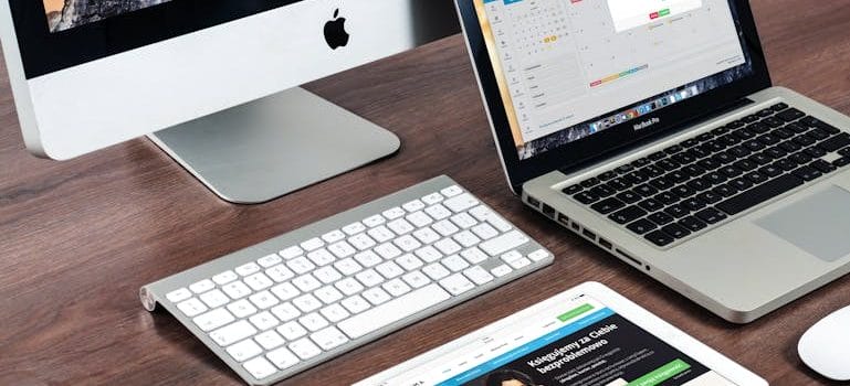 Turned on Imac Beside Macbook on Table