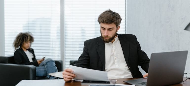 Man in Black Suit Jacket Analyzing Data Reports