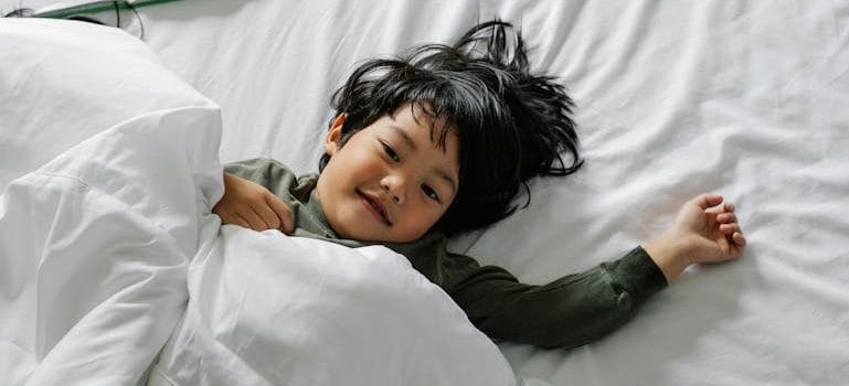 boy lying in bed after sleep