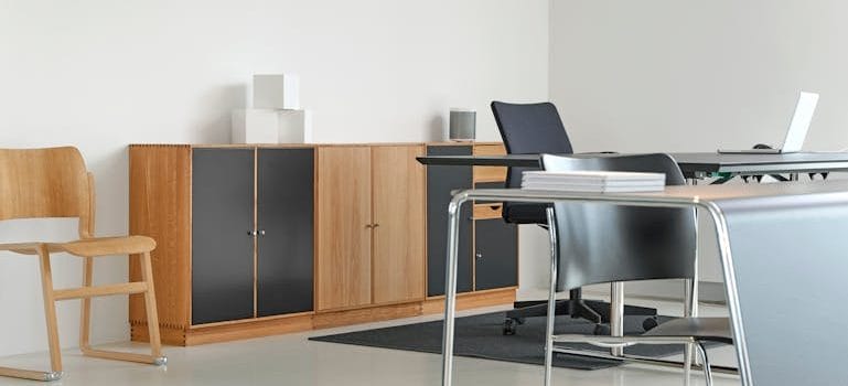 Black Padded Rolling Armchair Beside Desk