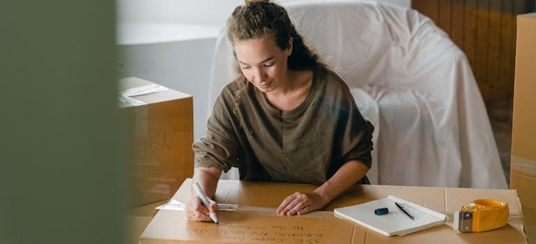 Woman signing box with marker
