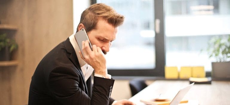 Person talking on the phone about What to Do if Your Moving Day is Hit by Unexpected Delays
