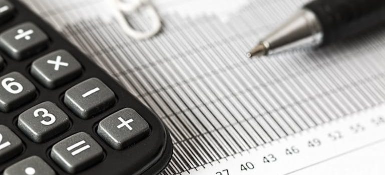 Calculator and Pen on Table