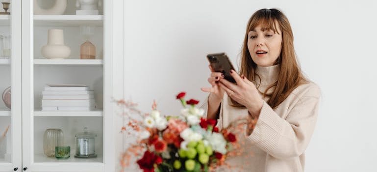 a woman taking a photo as part of creative moving tips you haven’t heard before