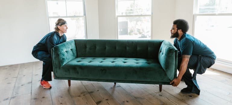 Two Men Carrying a Sofa