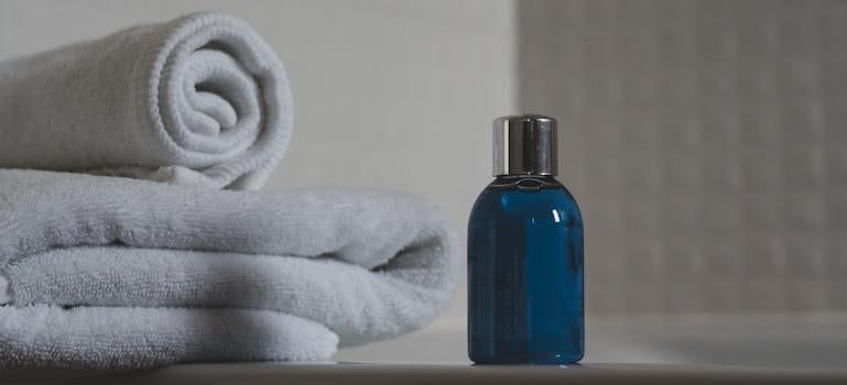 Blue Glass Bottle Beside White Towel