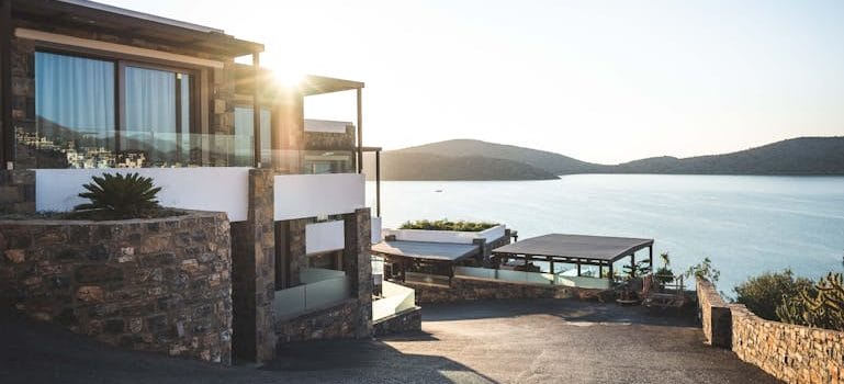 Sun Piercing of Brown Concrete House Near Sea