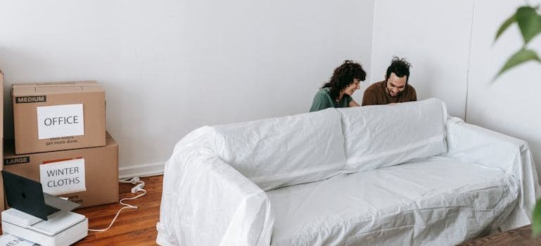a couple talking about Signs You Need Professional Movers for Your Next Move 