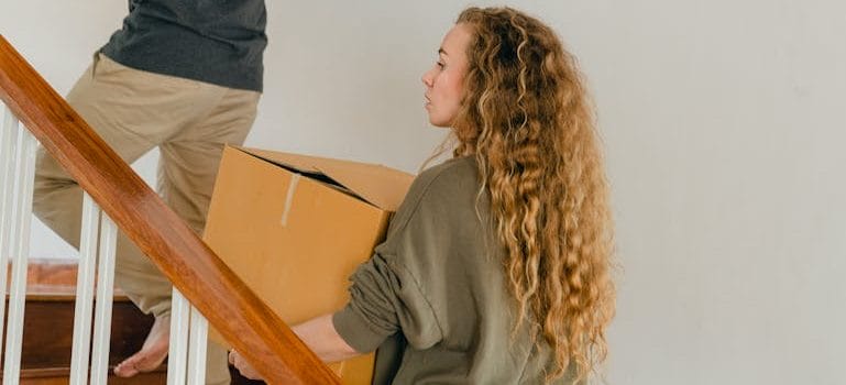 Young couple moving boxes into new apartment