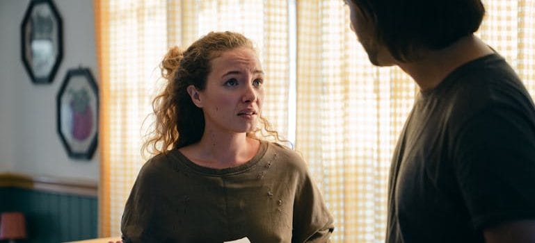 Couple talking while moving in new apartment