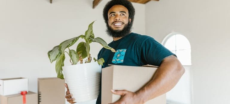 Man in Blue Crew Neck T-shirt Holding White Paper