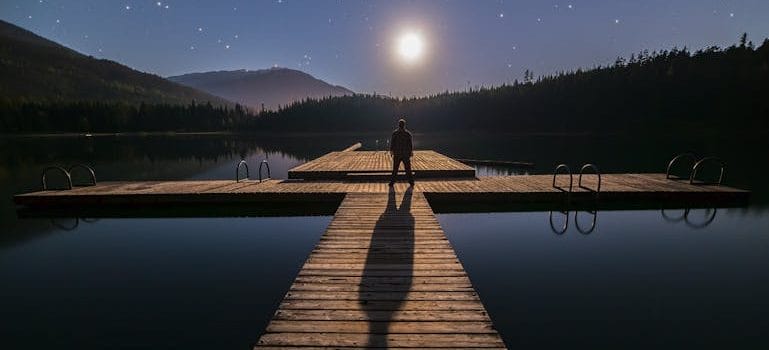 Silhouette of Person Standing on Bridge