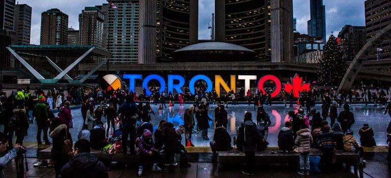 People Gathered in Front of Toronto Freestanding Signage