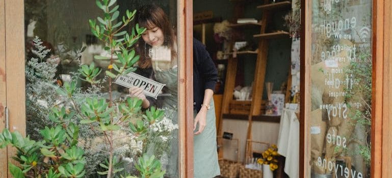 florist turning signboard on store wall