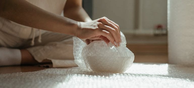 a person packing for moving minimalist