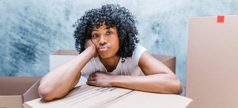 Woman Surrounded by Moving Boxes
