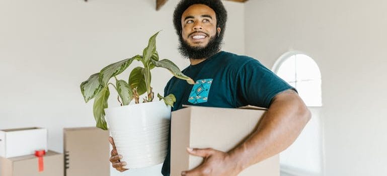 Man in Blue Crew Neck T-shirt Holding White Paper